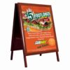 Double-sided wooden A-board poster stand with rich wood finish.